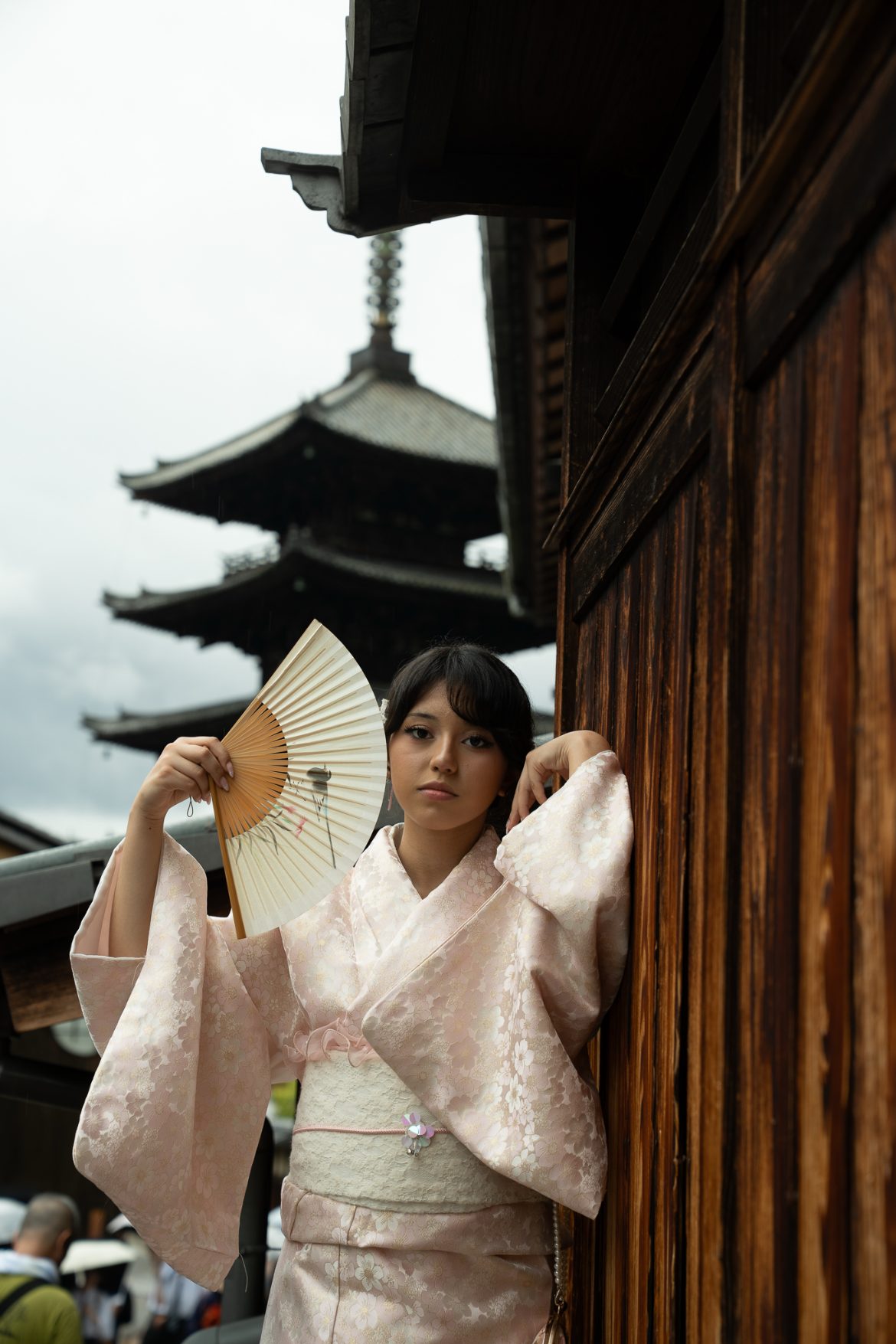 Arianna in a pink kimono with a folding fan
